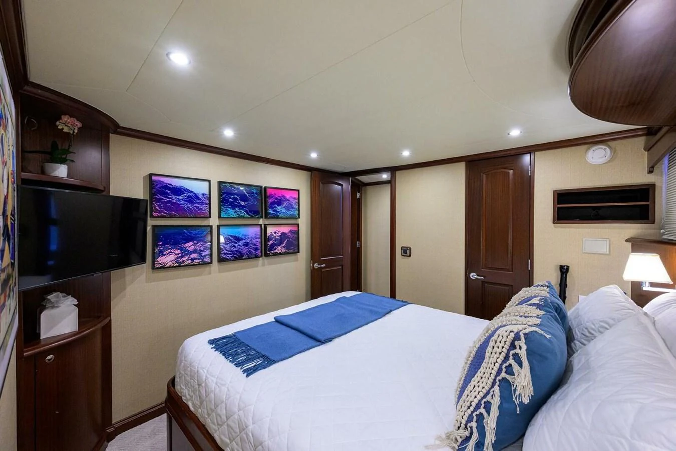 a bedroom with a bed and a television aboard JULE Yacht for Sale