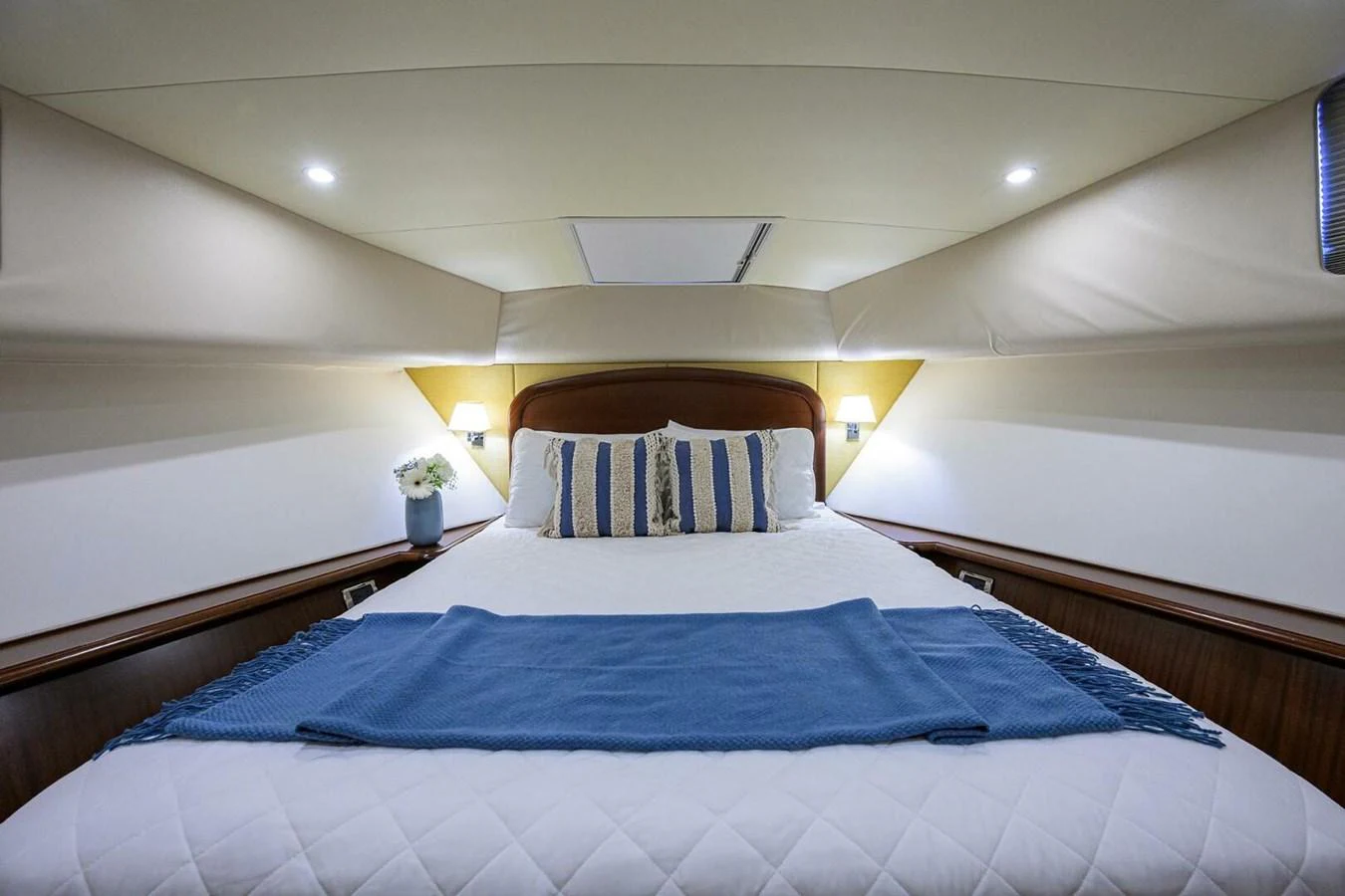 a bed with blue sheets aboard JULE Yacht for Sale