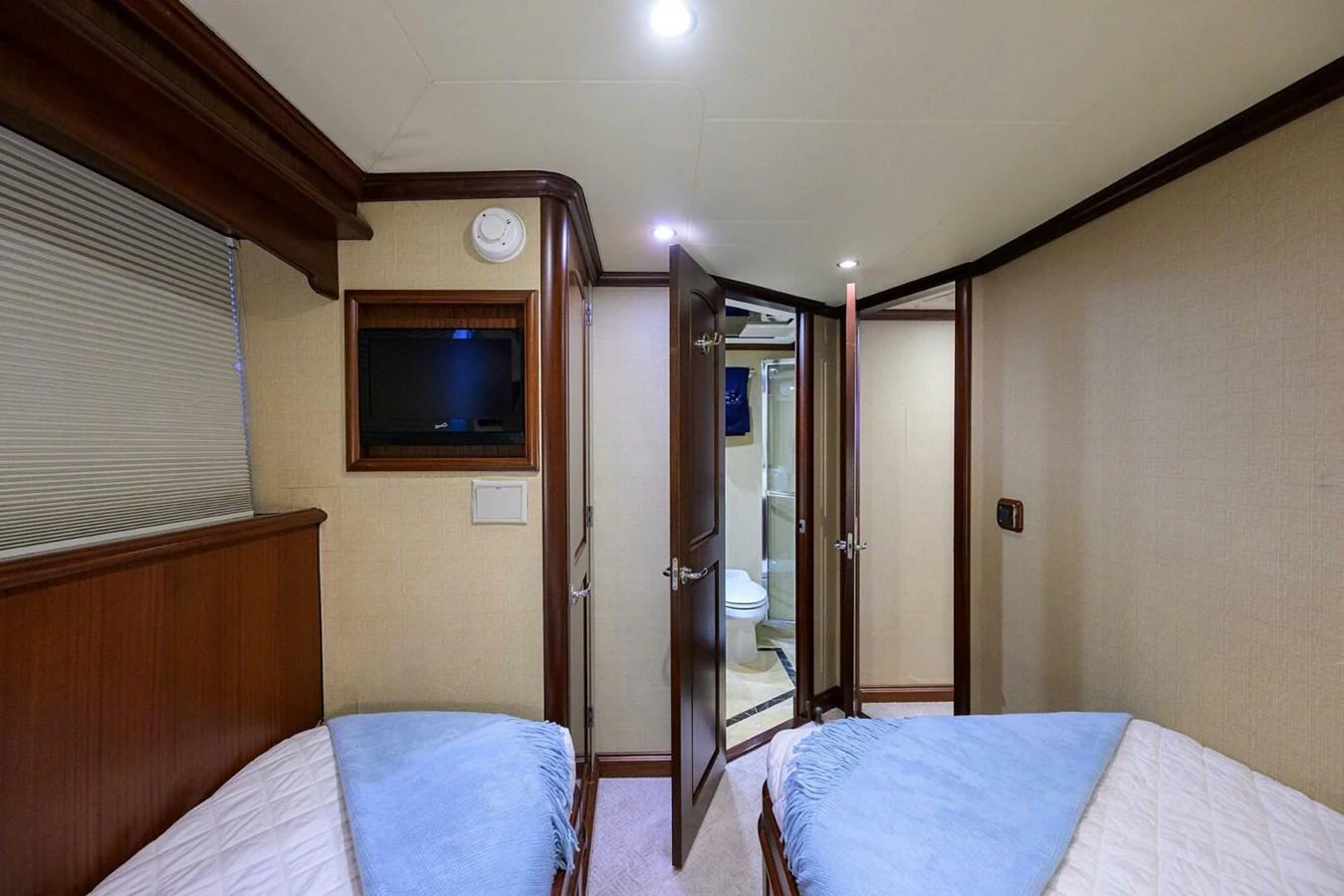 a bedroom with a tv and a bed aboard JULE Yacht for Sale