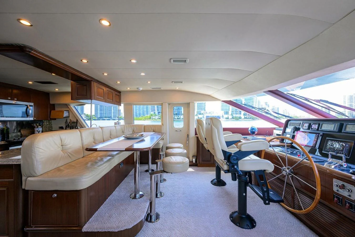 a room with tables and chairs aboard JULE Yacht for Sale