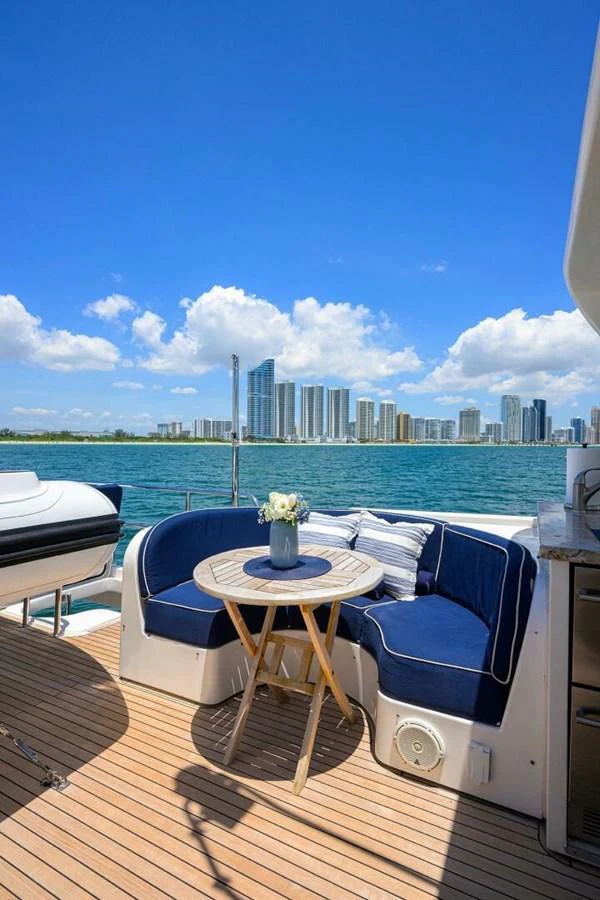 a table on a deck overlooking a city aboard JULE Yacht for Sale
