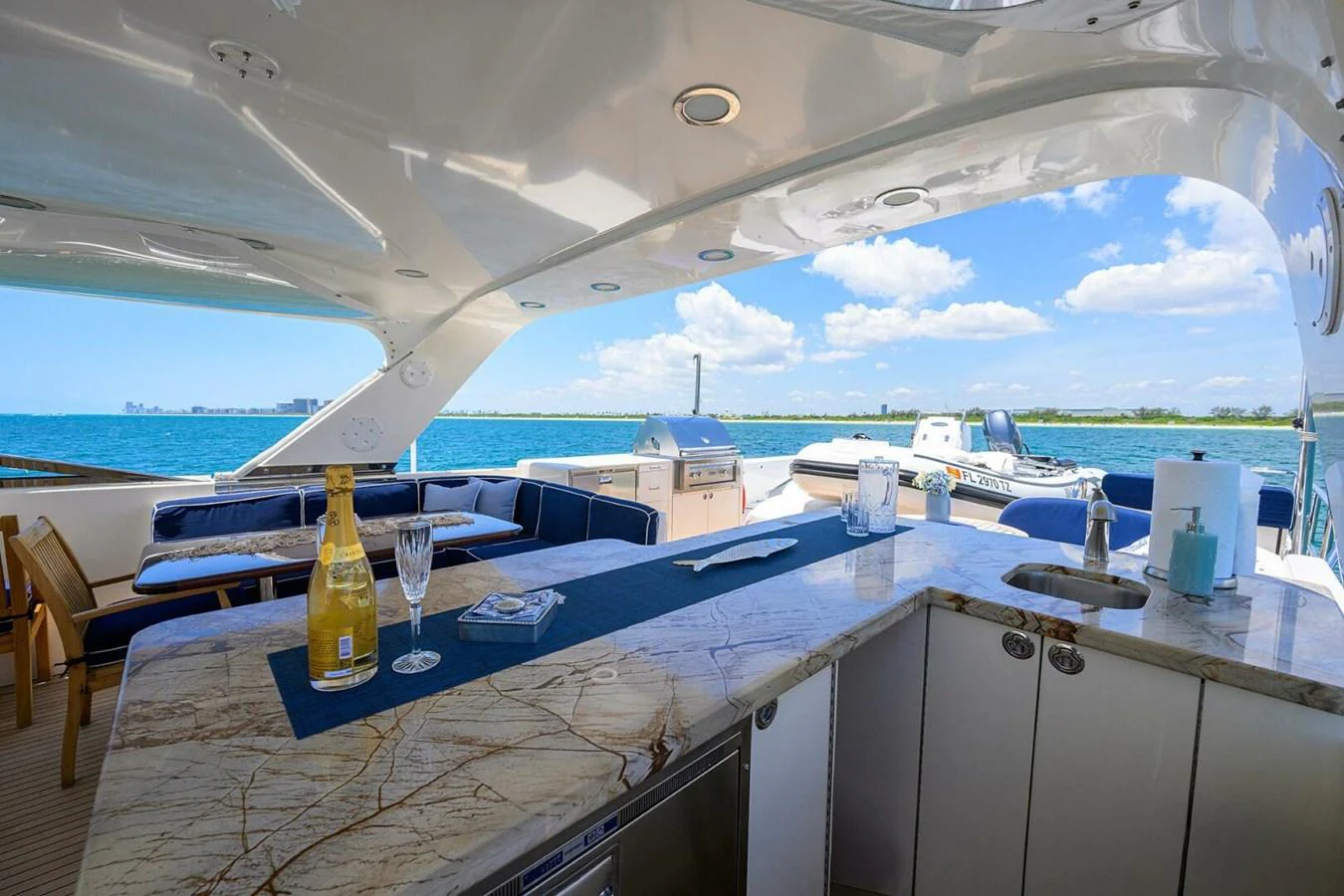 a large room with a table and chairs and a view of the ocean aboard JULE Yacht for Sale