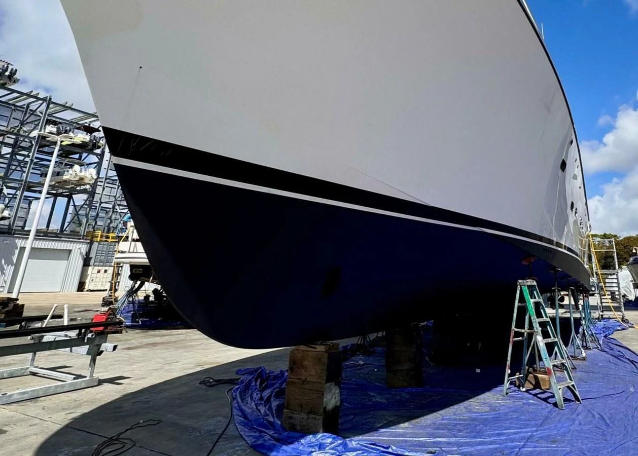a large white boat on a dock aboard JULE Yacht for Sale