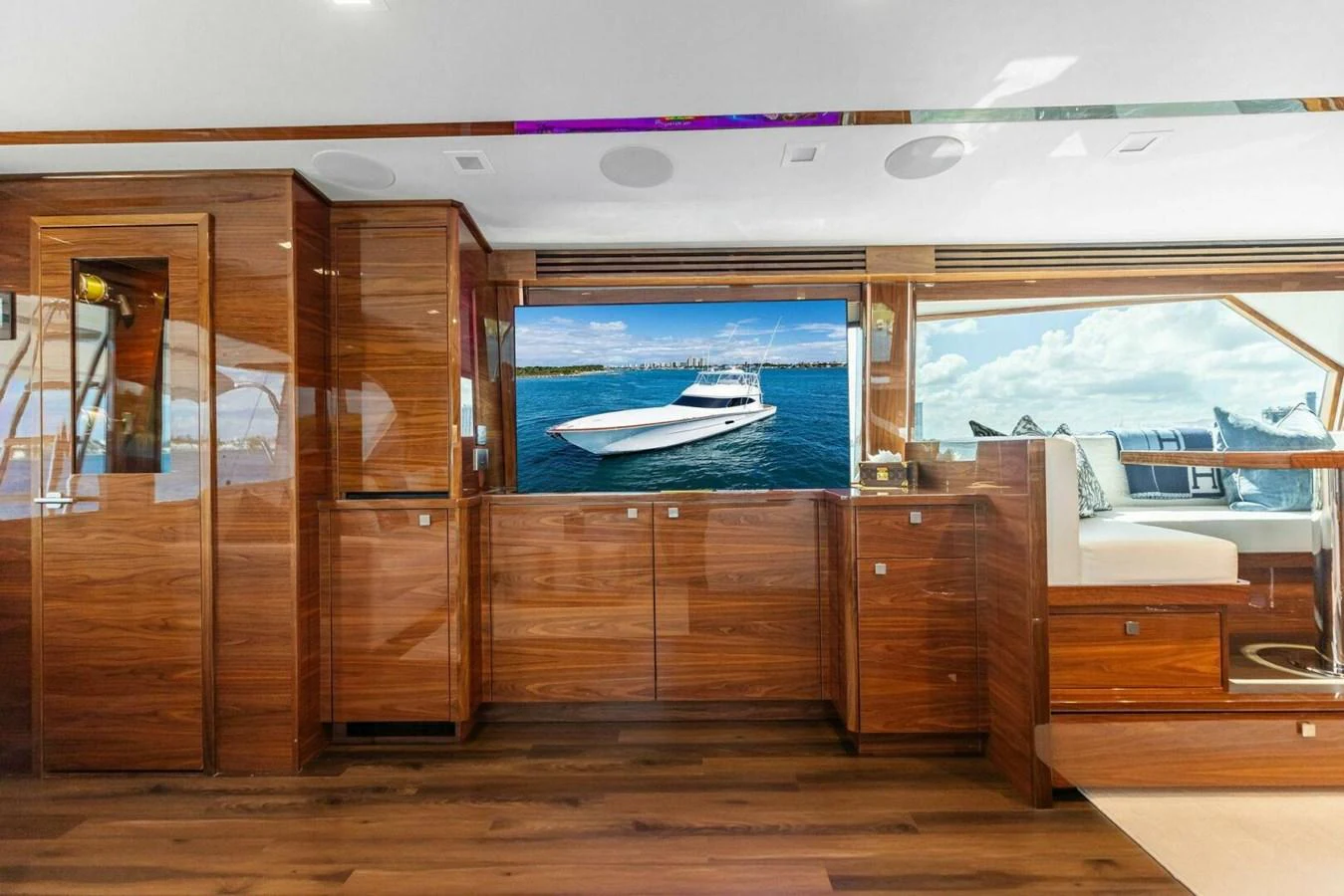 The interior of the yacht features luxurious wooden cabinetry and a large window with a stunning view of the water. aboard TEAM HARVEY I Yacht for Sale