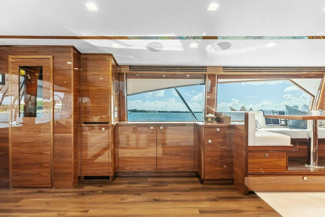 The yacht's interior features elegant wood paneling and large windows offering stunning ocean views. aboard TEAM HARVEY I Yacht for Sale