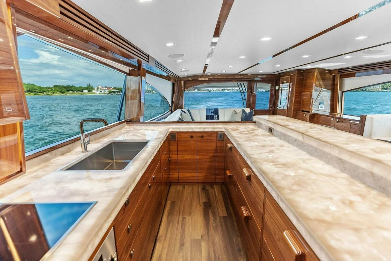 The yacht's galley features luxurious wood finishes and expansive windows offering stunning water views. aboard TEAM HARVEY I Yacht for Sale