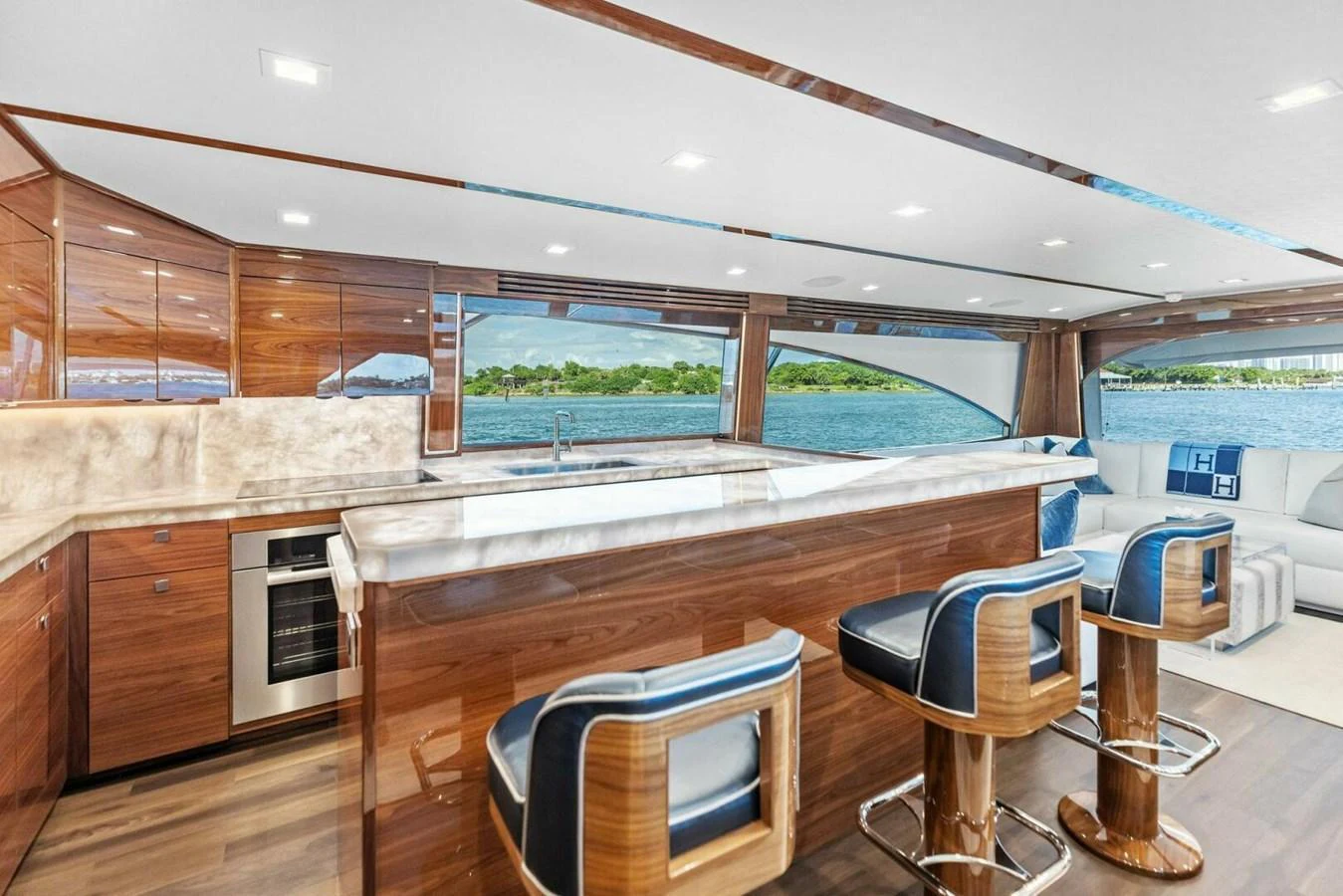 The yacht's galley features a sleek design with modern appliances and a spacious seating area overlooking the water. aboard TEAM HARVEY I Yacht for Sale