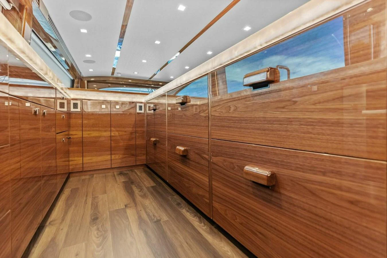 The image showcases a luxurious interior space with polished wooden cabinetry and modern lighting. aboard TEAM HARVEY I Yacht for Sale
