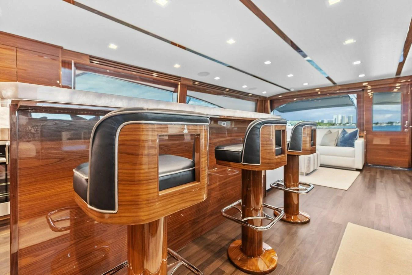 The yacht's saloon features luxurious bar seating with a panoramic view. aboard TEAM HARVEY I Yacht for Sale