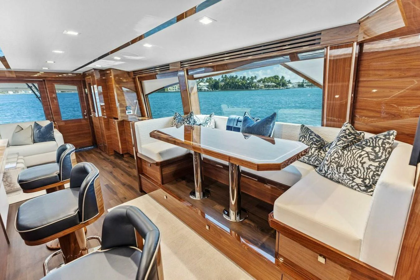 The yacht's salon features elegant wood finishes, plush seating, and large windows offering stunning ocean views. aboard TEAM HARVEY I Yacht for Sale