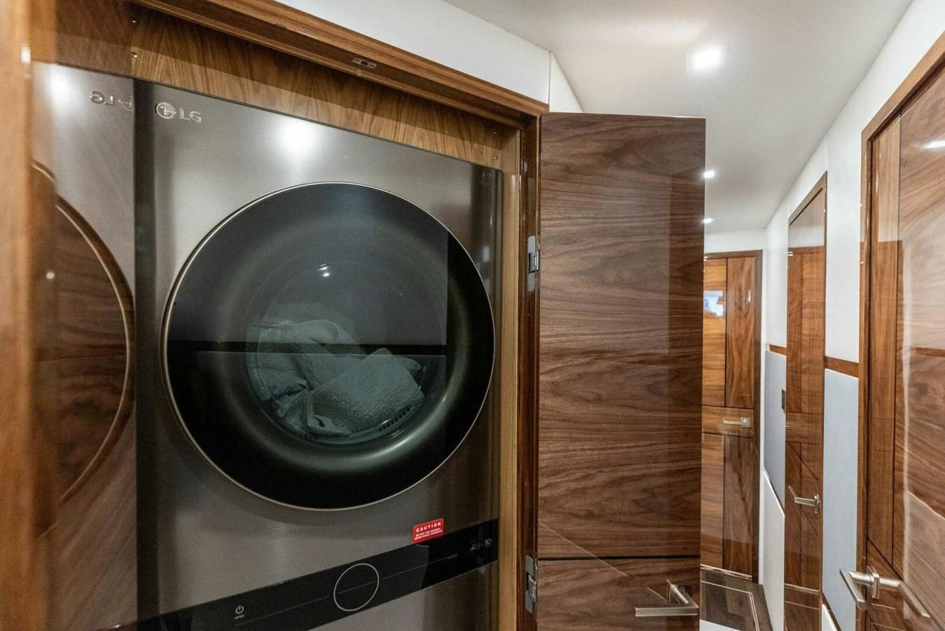 The yacht features a modern laundry room with a high-end washer and dryer. aboard TEAM HARVEY I Yacht for Sale
