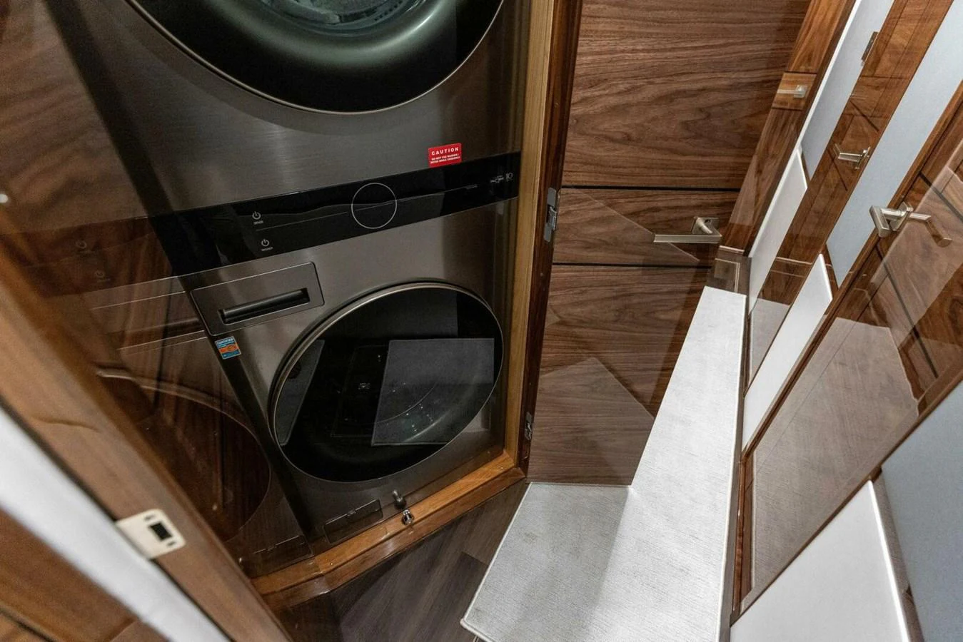The yacht features a compact and efficient laundry area with modern appliances. aboard TEAM HARVEY I Yacht for Sale
