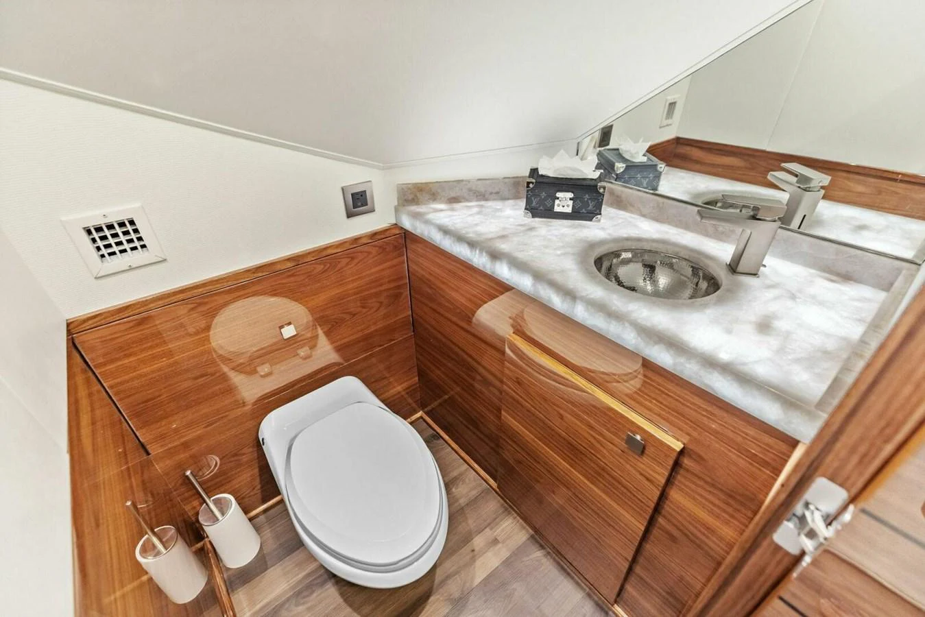 The yacht's head features a sleek design with a modern sink and wooden cabinetry. aboard TEAM HARVEY I Yacht for Sale