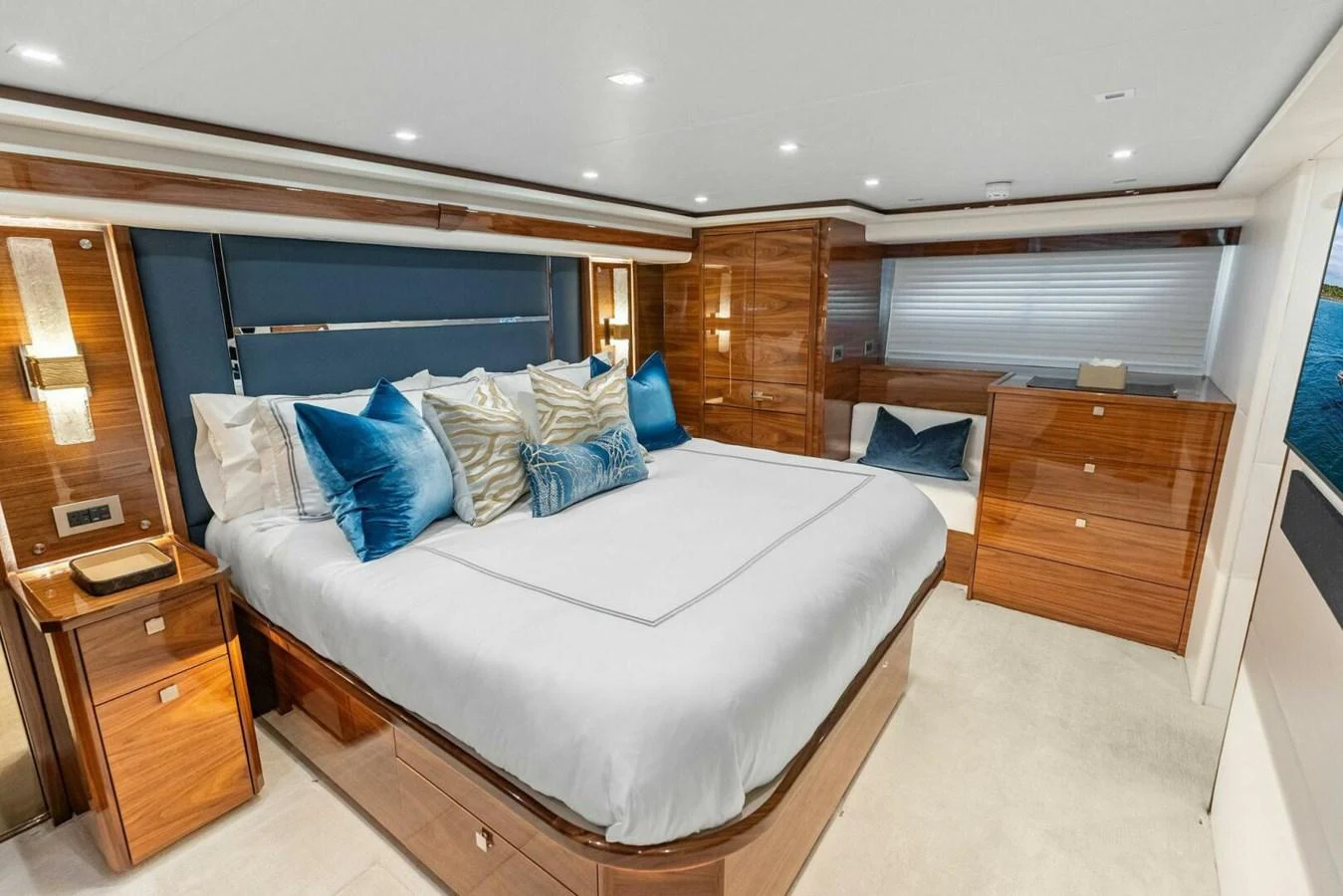The master stateroom features a luxurious bed with plush pillows and elegant wood finishes. aboard TEAM HARVEY I Yacht for Sale