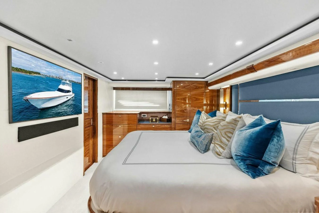 The stateroom features a luxurious bed with plush pillows and elegant wood paneling. aboard TEAM HARVEY I Yacht for Sale