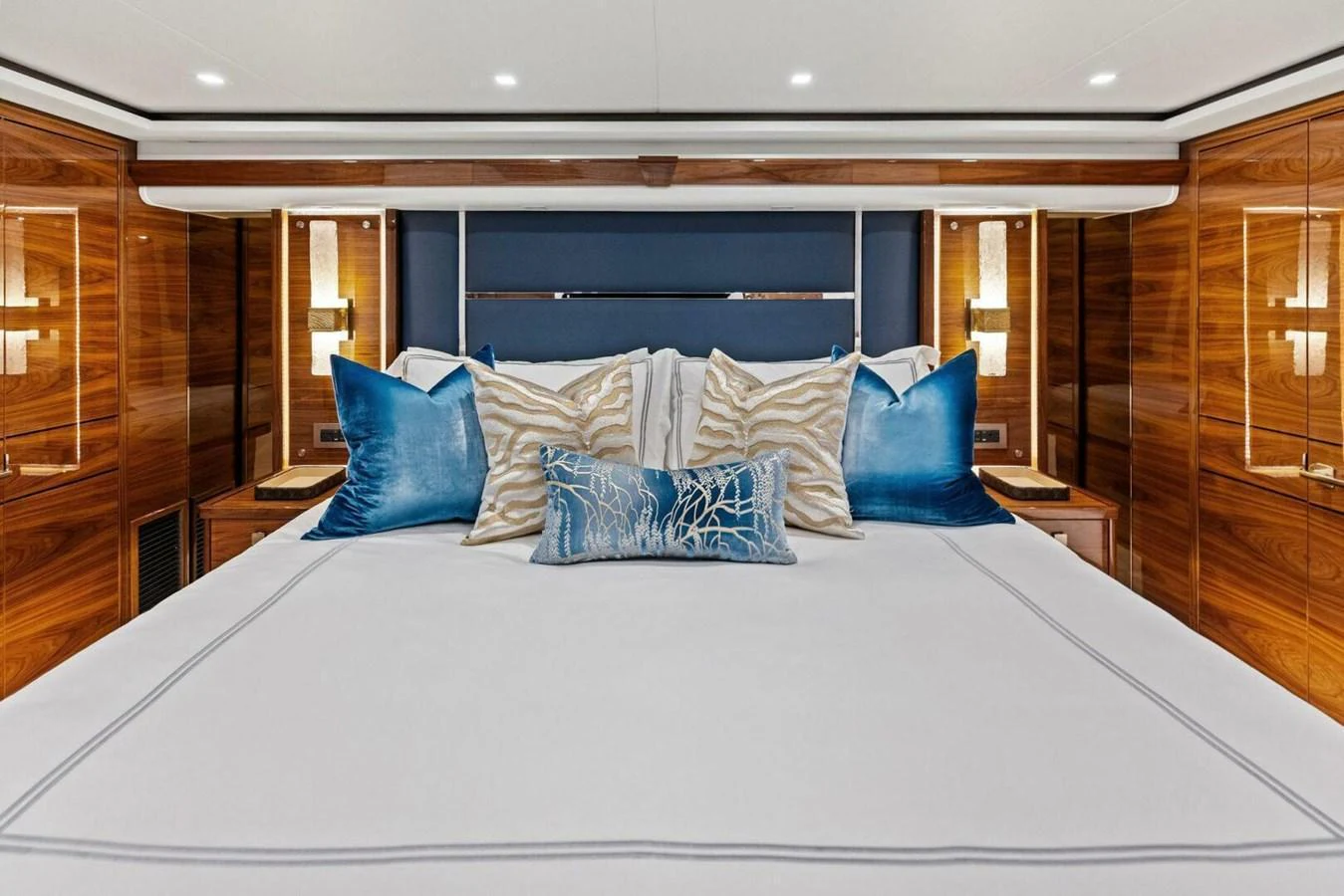 The master stateroom features luxurious bedding and elegant wood paneling. aboard TEAM HARVEY I Yacht for Sale