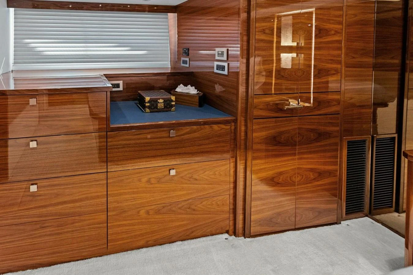 The yacht's interior features elegant wooden cabinetry and a plush carpeted floor. aboard TEAM HARVEY I Yacht for Sale