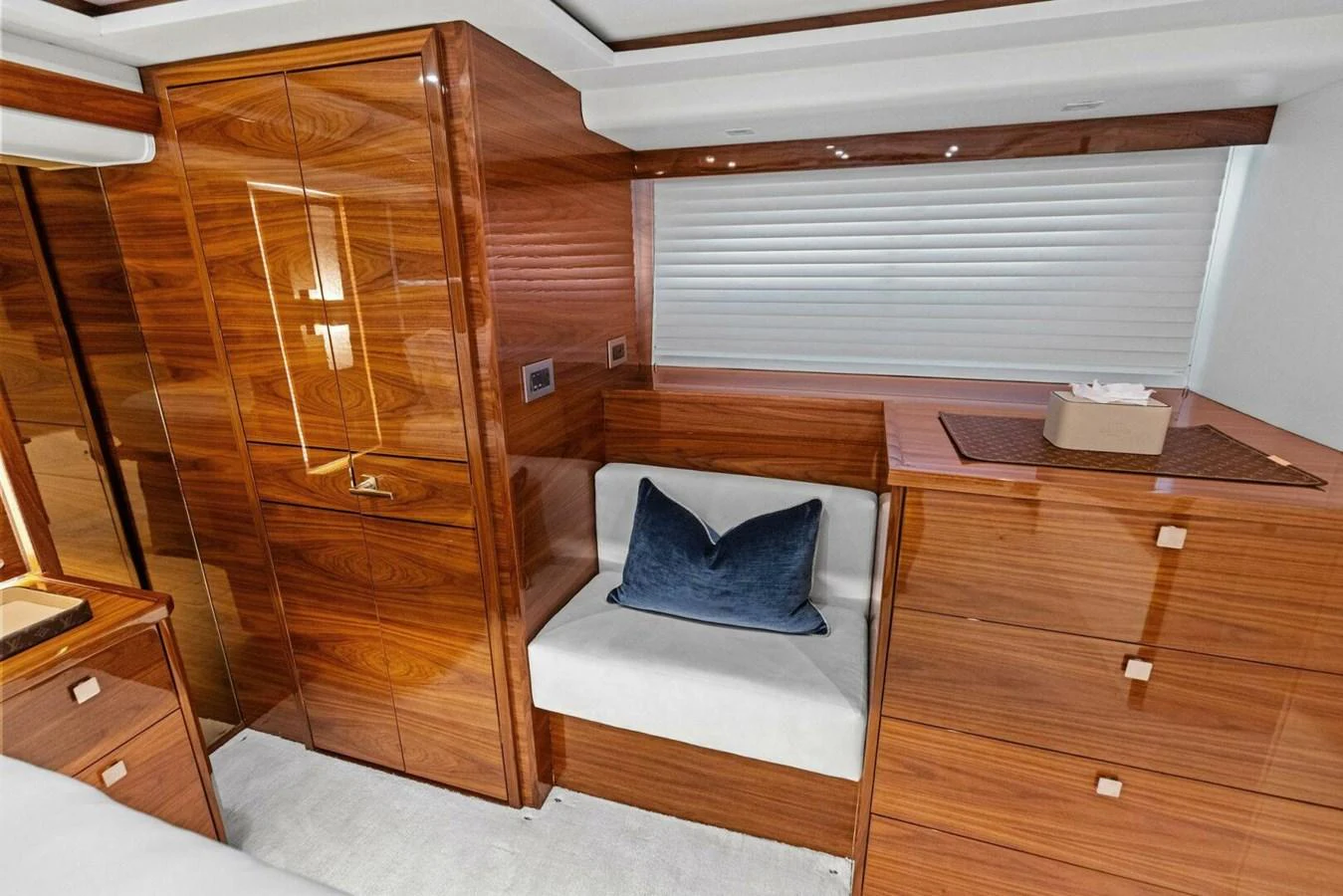 The yacht's interior features luxurious wooden cabinetry and a cozy seating area with a plush cushion. aboard TEAM HARVEY I Yacht for Sale
