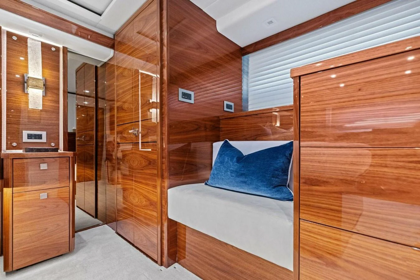 The yacht's interior features luxurious wooden paneling and a comfortable seating area with a plush blue cushion. aboard TEAM HARVEY I Yacht for Sale