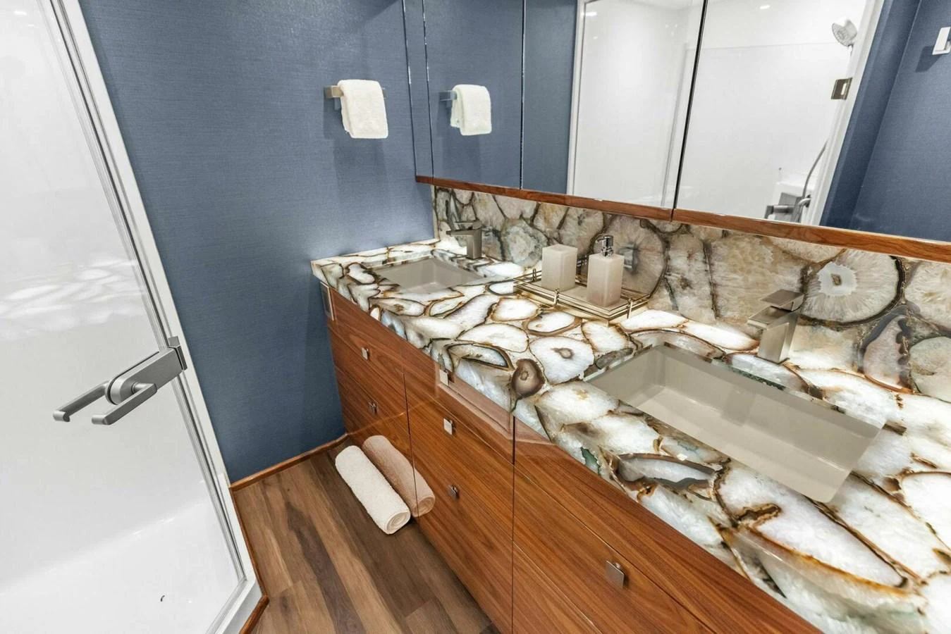 The yacht's bathroom features a luxurious marble countertop and modern fixtures. aboard TEAM HARVEY I Yacht for Sale