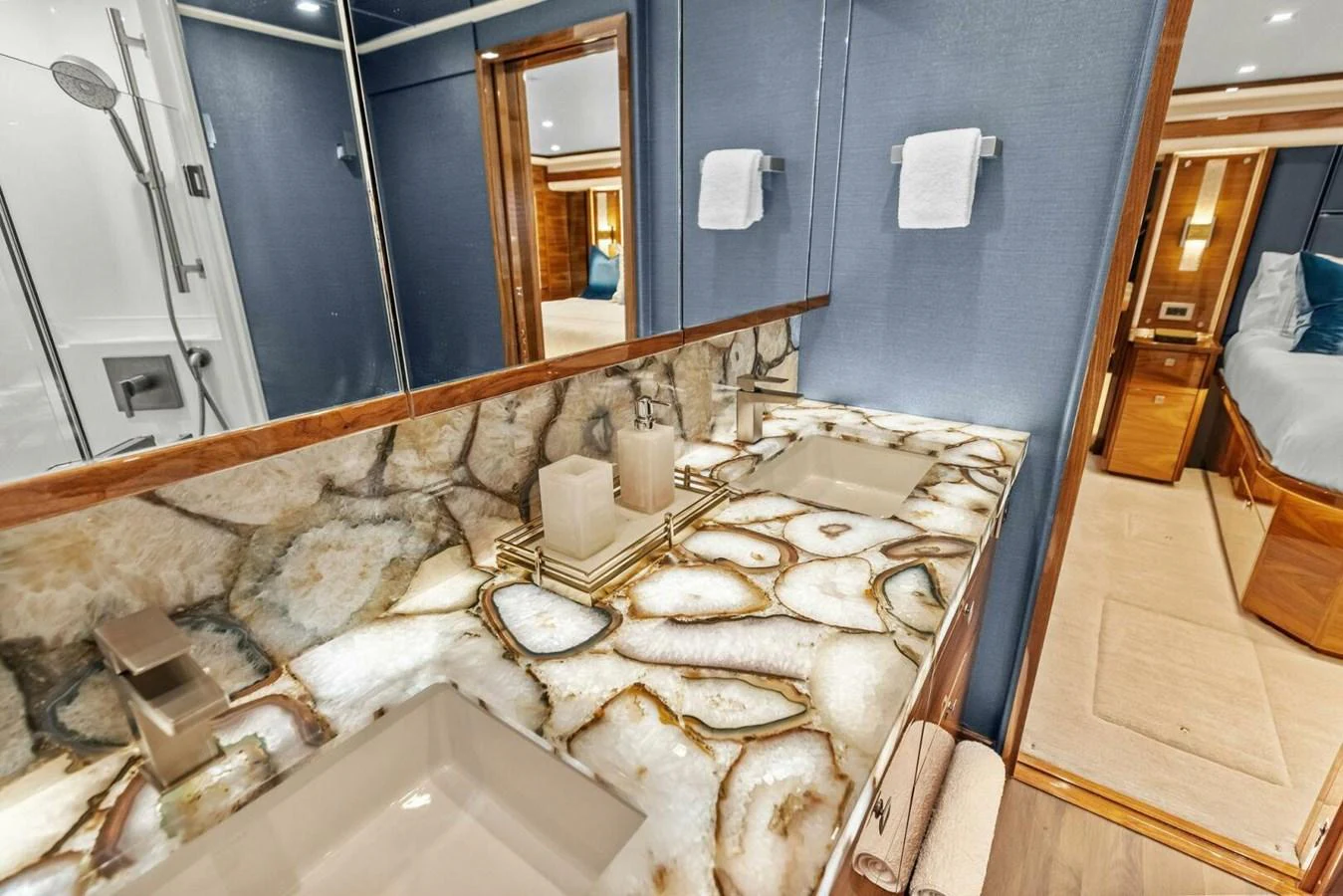 The yacht's bathroom features a luxurious design with a stunning stone countertop and modern fixtures. aboard TEAM HARVEY I Yacht for Sale