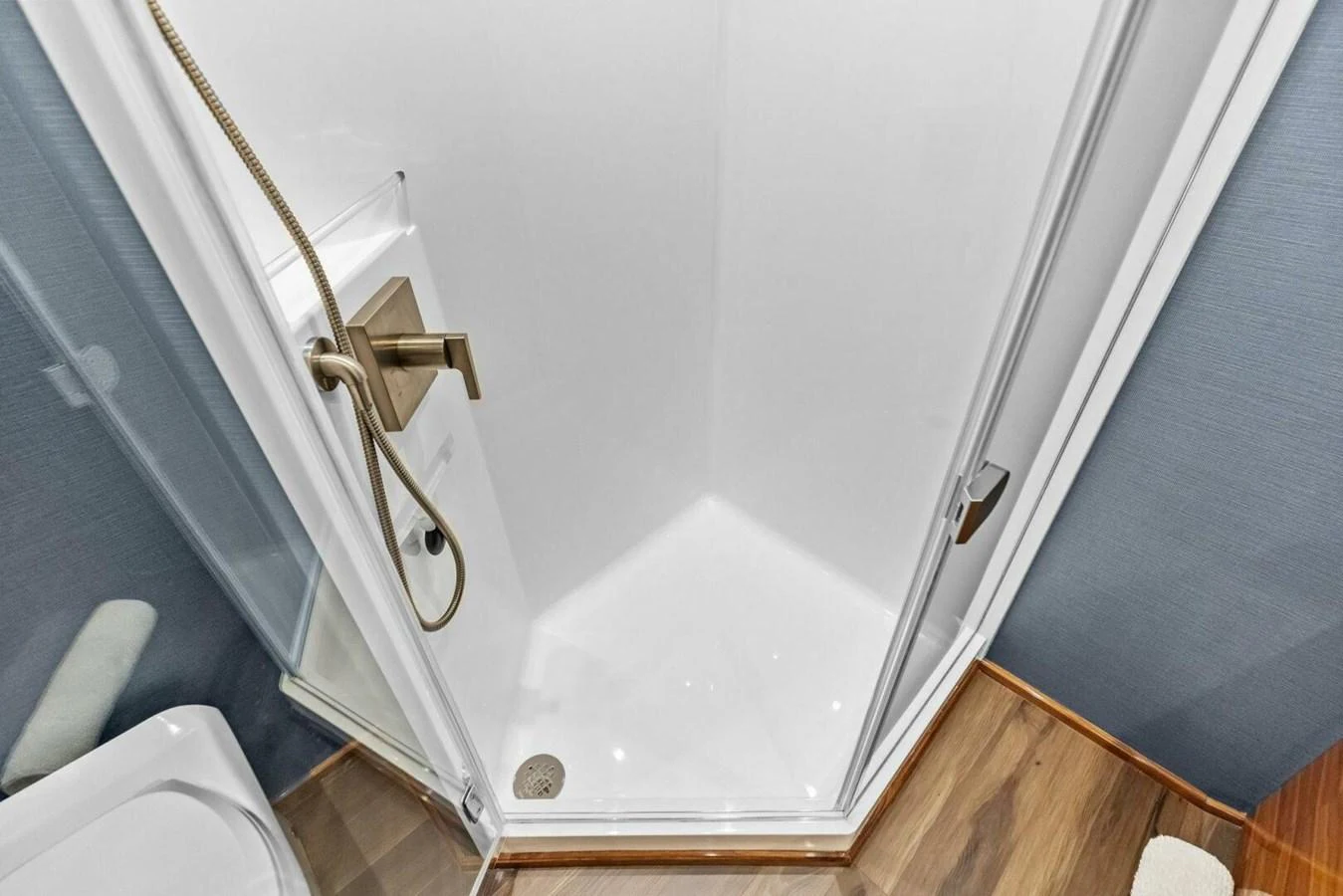The yacht's bathroom features a sleek shower with modern fixtures and a clean design. aboard TEAM HARVEY I Yacht for Sale