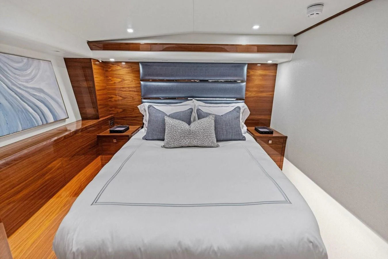 The stateroom features a luxurious bed with elegant wood paneling and modern decor. aboard TEAM HARVEY I Yacht for Sale