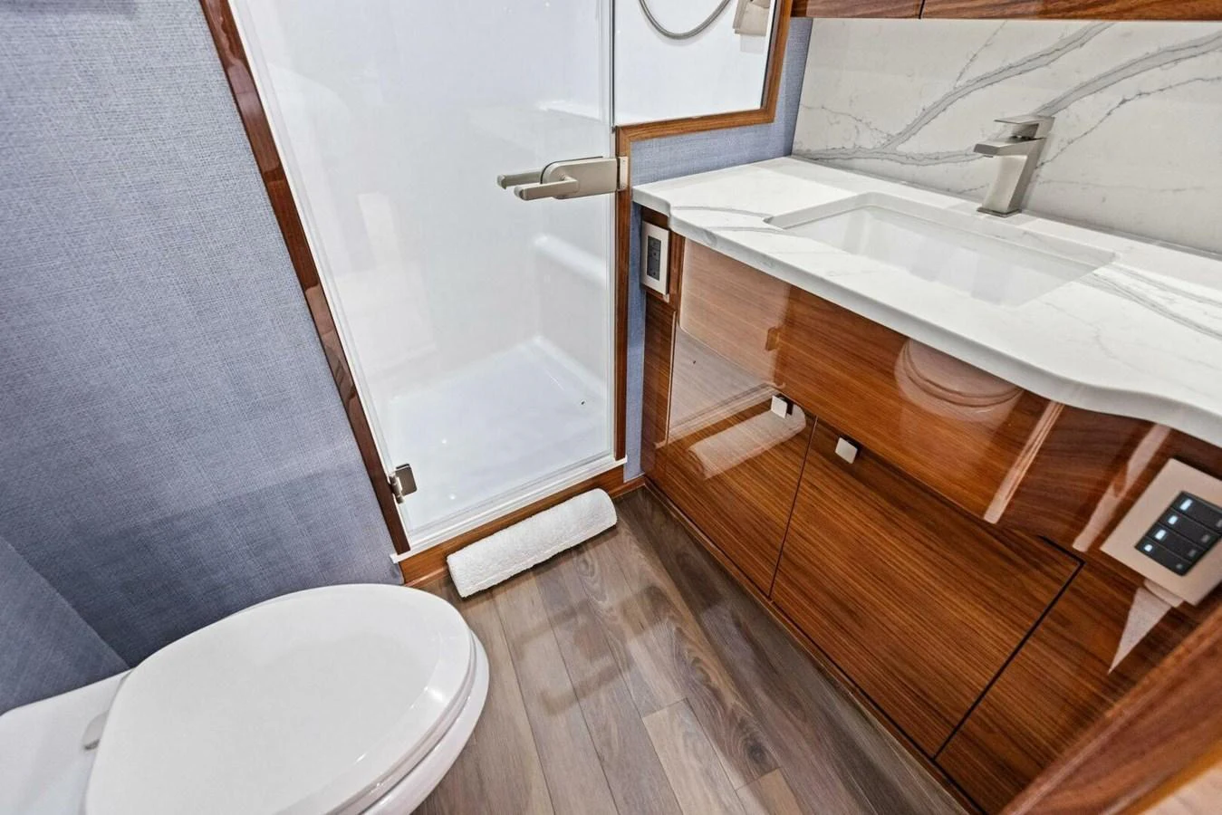 The yacht's bathroom features modern fixtures and elegant wood finishes. aboard TEAM HARVEY I Yacht for Sale