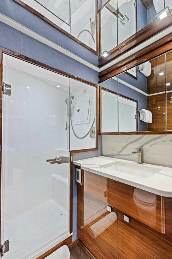 The yacht's bathroom features modern fixtures and a sleek design with ample storage space. aboard TEAM HARVEY I Yacht for Sale