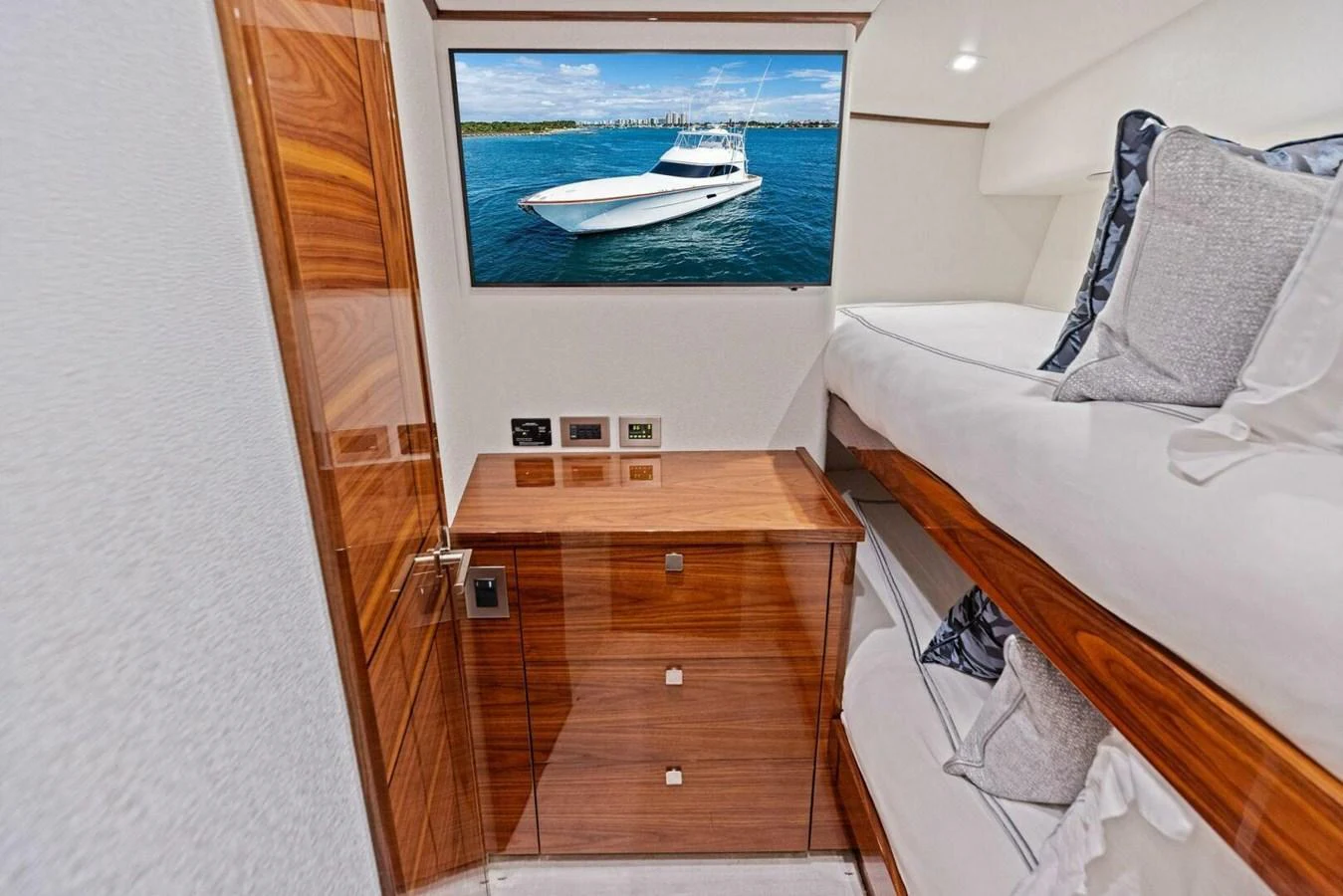 A cozy cabin with bunk beds and a view of the sea through a window. aboard TEAM HARVEY I Yacht for Sale