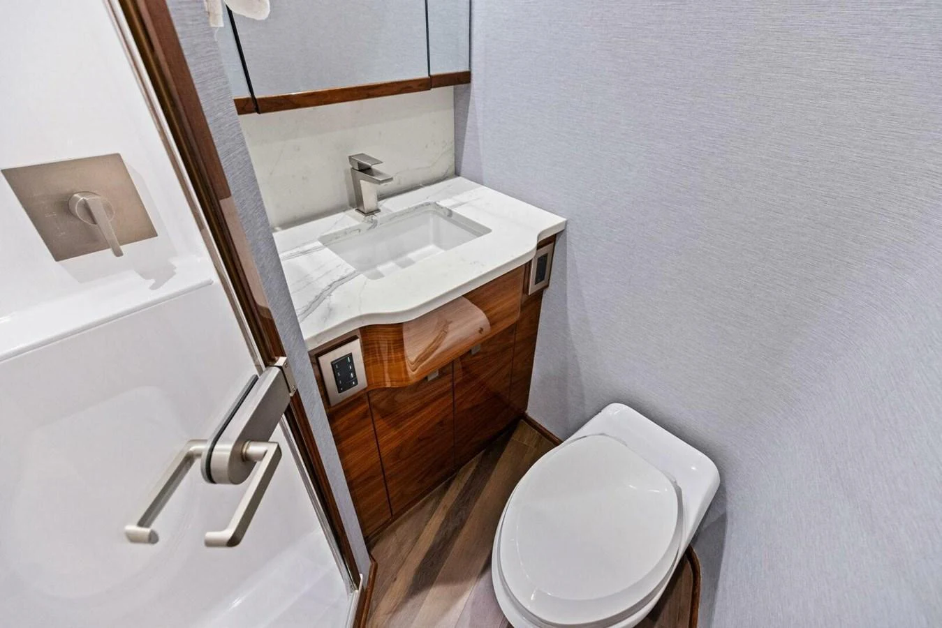 The yacht's head features a modern sink and toilet with sleek finishes. aboard TEAM HARVEY I Yacht for Sale
