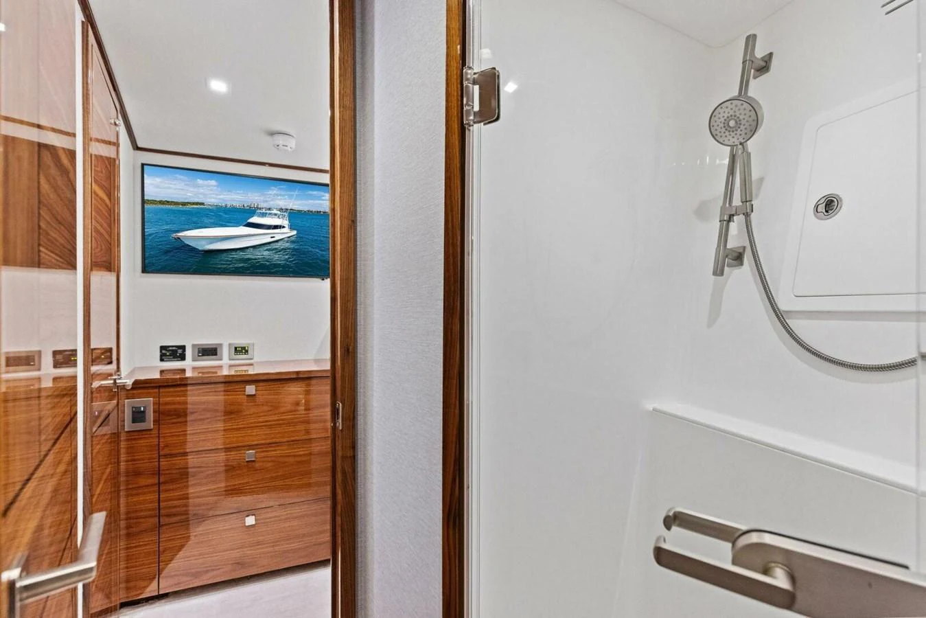 The yacht's bathroom features sleek wood finishes and modern fixtures, creating a luxurious and inviting space. aboard TEAM HARVEY I Yacht for Sale