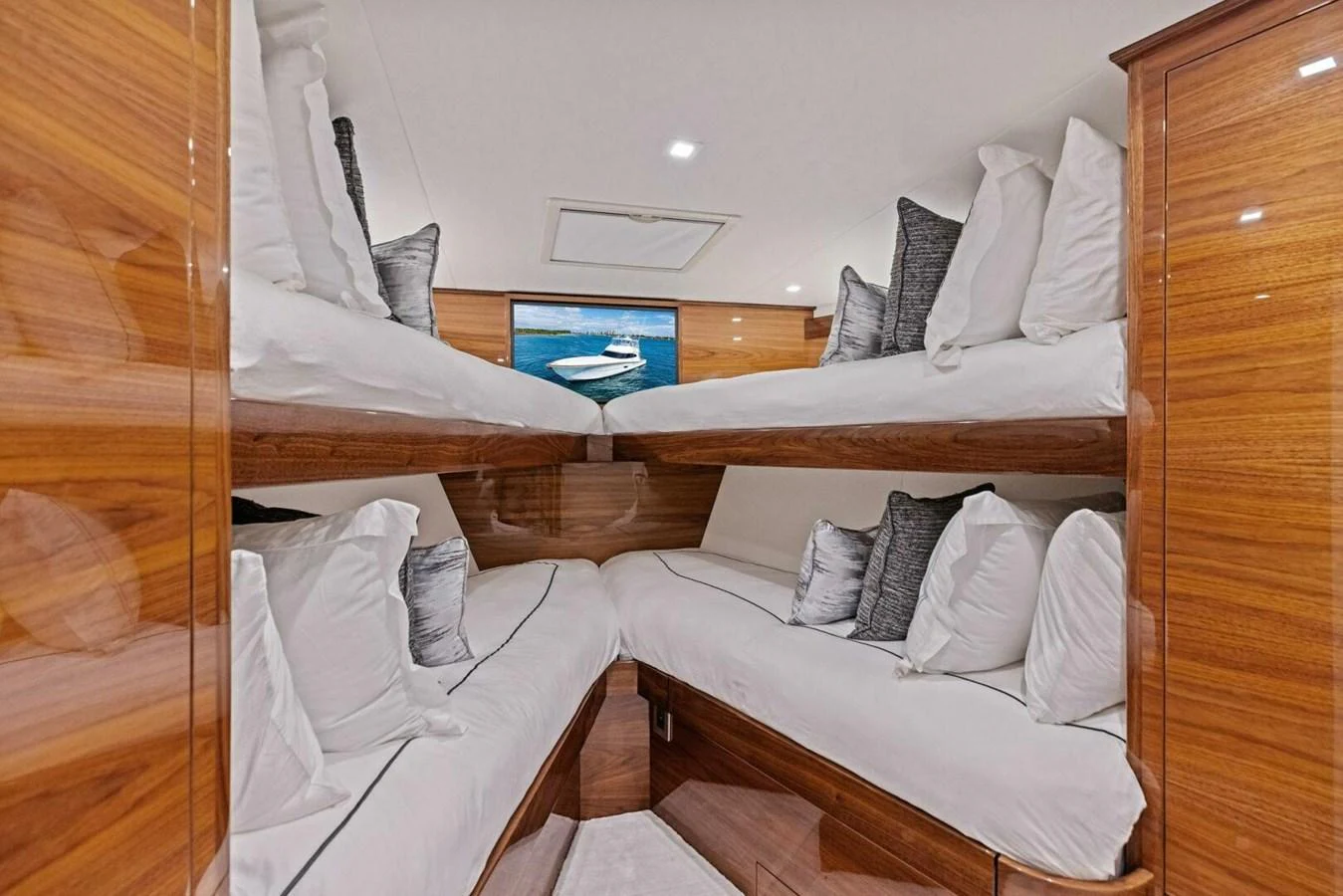 The cabin features cozy bunk beds with plush pillows and a sleek wooden finish. aboard TEAM HARVEY I Yacht for Sale