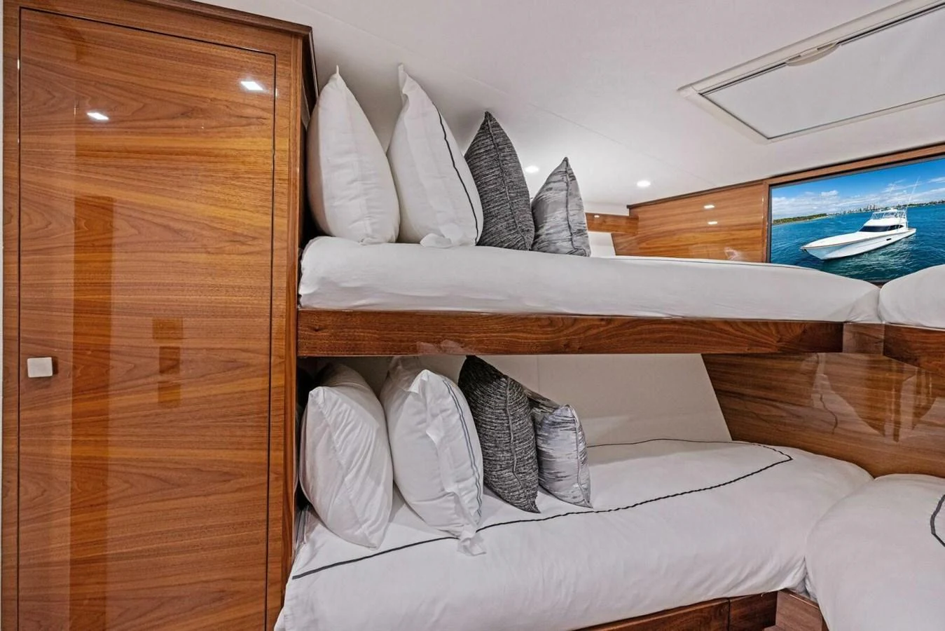 The cozy bunk room features polished wood finishes and comfortable bedding, perfect for restful nights at sea. aboard TEAM HARVEY I Yacht for Sale