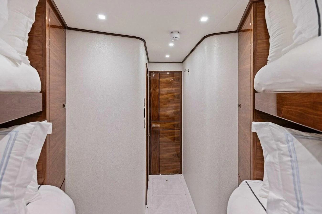 This image showcases a cozy cabin with bunk beds and elegant wood finishes. aboard TEAM HARVEY I Yacht for Sale