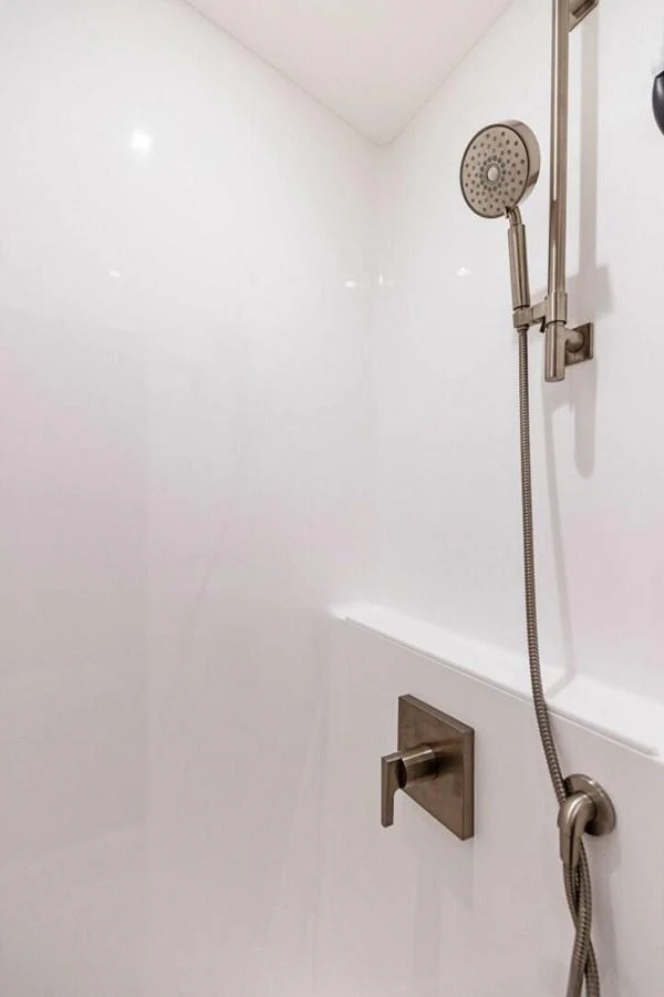 A sleek and modern shower area with a handheld showerhead and minimalist fixtures. aboard TEAM HARVEY I Yacht for Sale