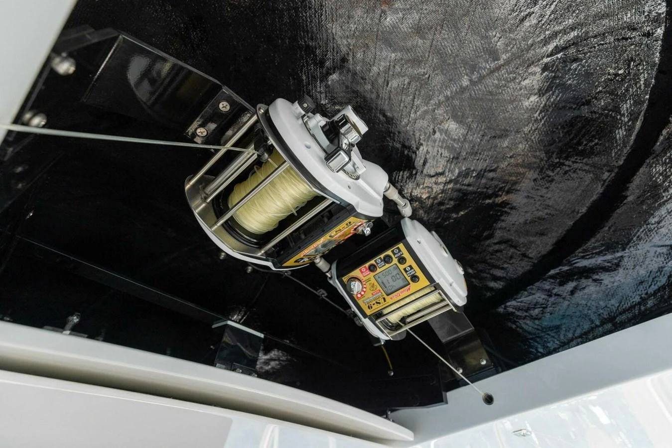 The image showcases a detailed view of the yacht's fishing equipment mounted on the ceiling. aboard TEAM HARVEY I Yacht for Sale