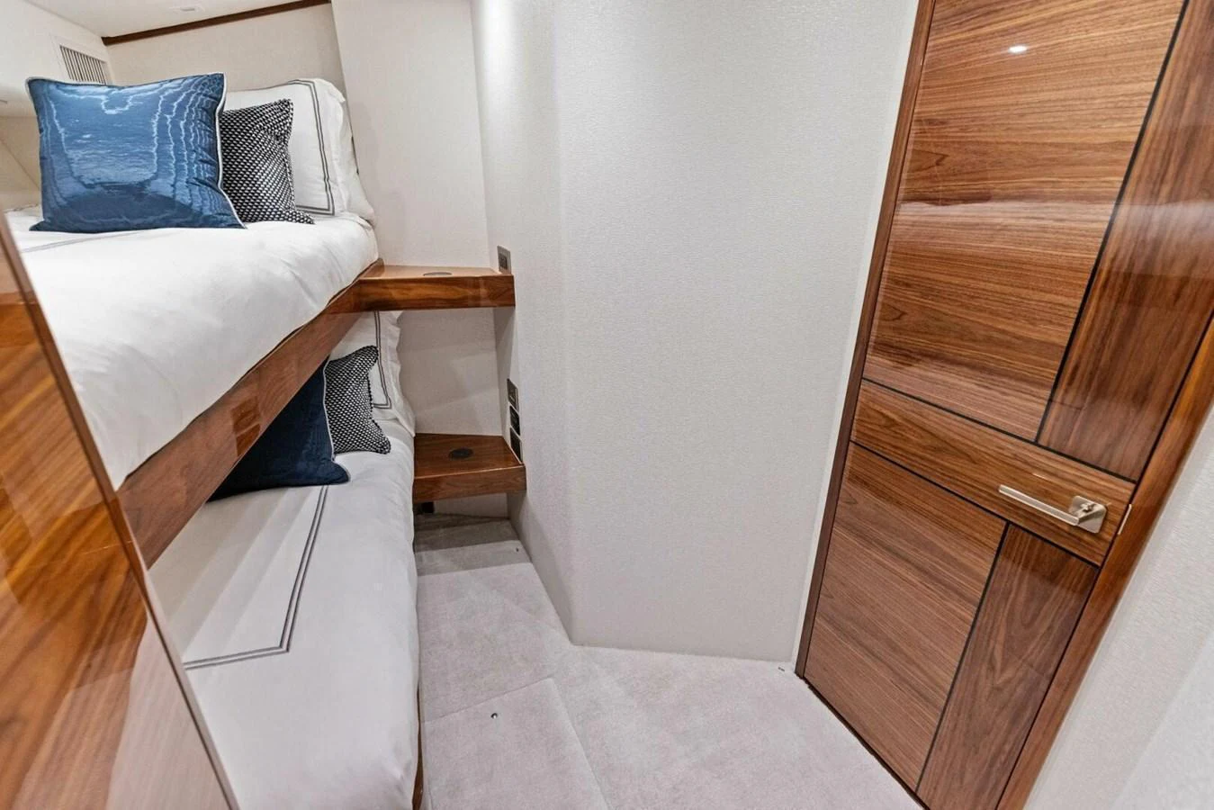 The guest cabin features cozy bunk beds with elegant wooden finishes and plush bedding. aboard TEAM HARVEY I Yacht for Sale