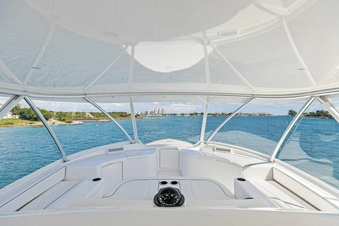 The helm area offers a panoramic view of the serene waters and distant shoreline. aboard TEAM HARVEY I Yacht for Sale