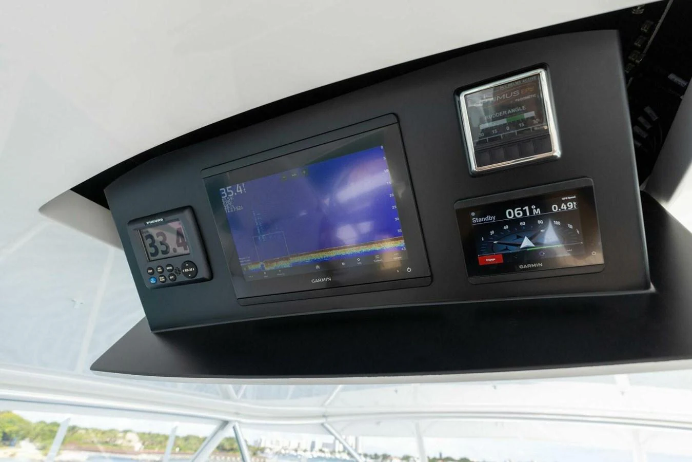 The helm features advanced navigation and monitoring equipment for a seamless sailing experience. aboard TEAM HARVEY I Yacht for Sale