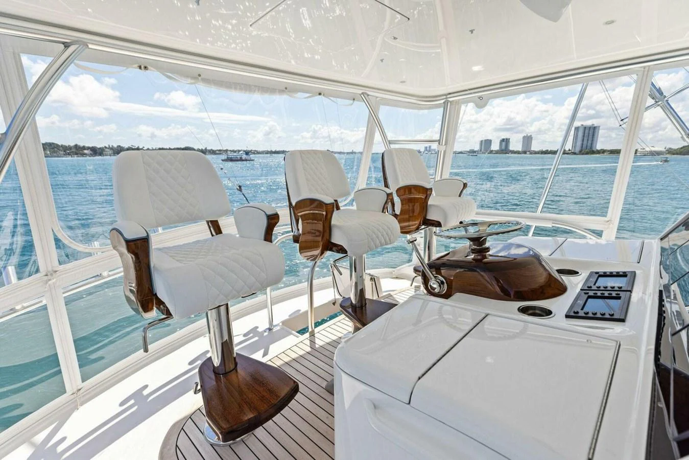The helm area features luxurious seating with a panoramic view of the surrounding waters. aboard TEAM HARVEY I Yacht for Sale