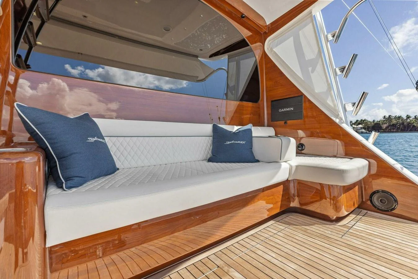 The aft deck features a comfortable seating area with plush cushions and a polished wooden finish. aboard TEAM HARVEY I Yacht for Sale