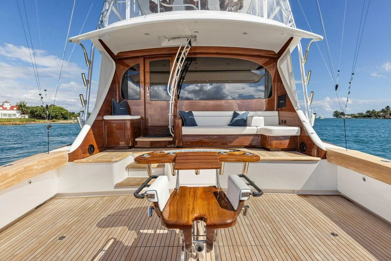 The aft deck offers a spacious and inviting area for relaxation and entertainment with comfortable seating and a beautiful wooden table. aboard TEAM HARVEY I Yacht for Sale