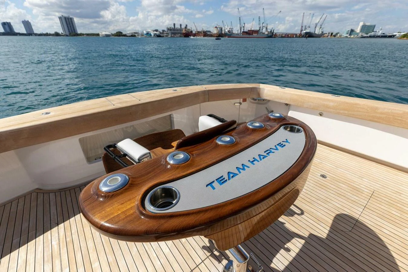 The aft deck features a custom fishing station with rod holders and a polished wood finish. aboard TEAM HARVEY I Yacht for Sale