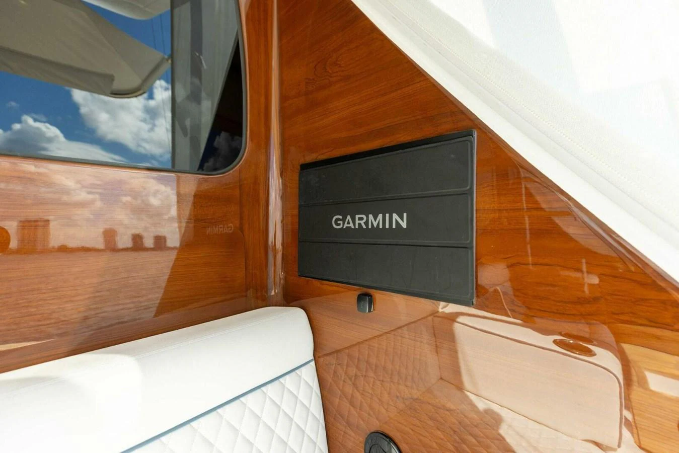 A close-up of a Garmin navigation system installed on a polished wooden panel. aboard TEAM HARVEY I Yacht for Sale