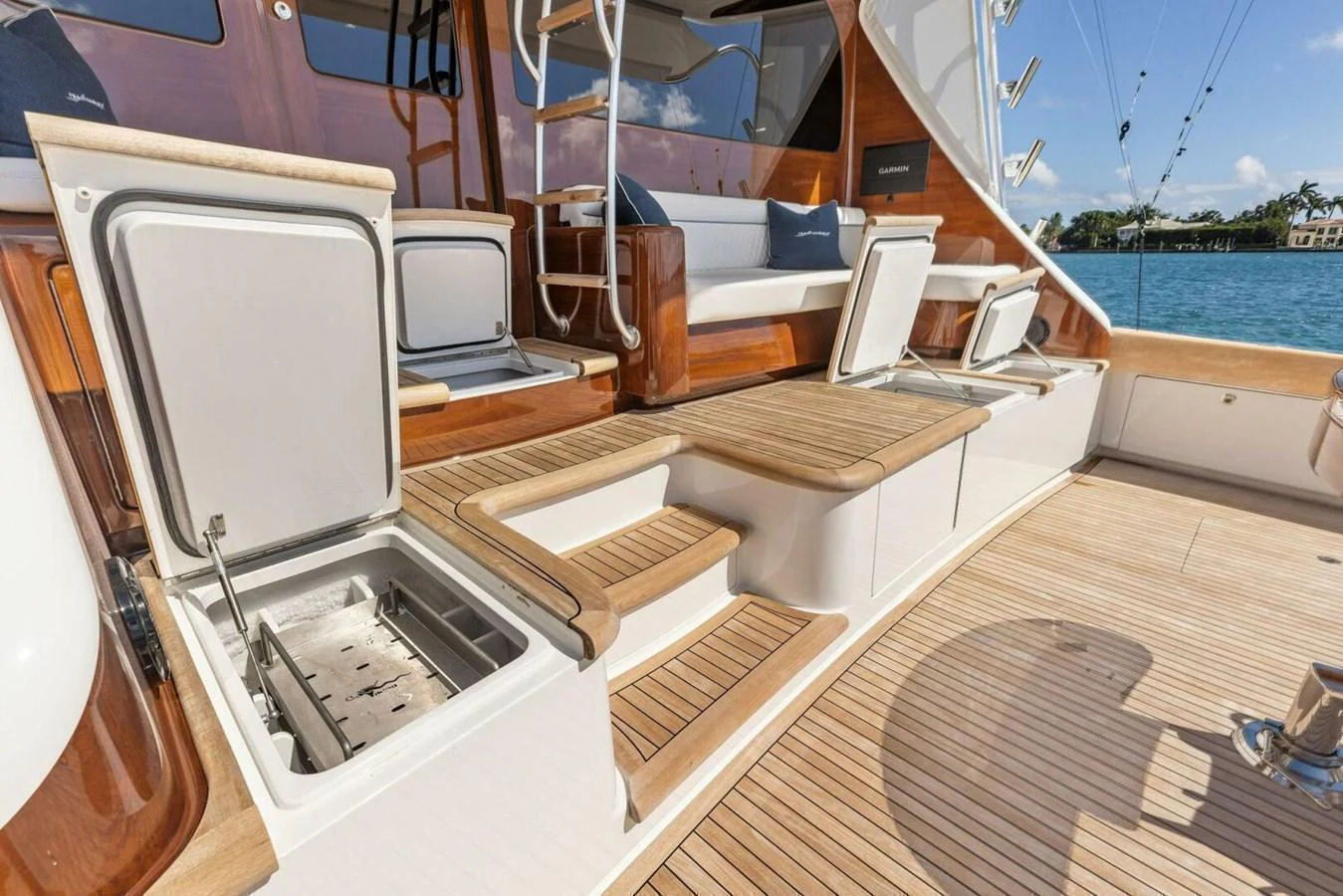 The aft deck features elegant wooden finishes and practical storage compartments, perfect for a luxurious outdoor experience. aboard TEAM HARVEY I Yacht for Sale