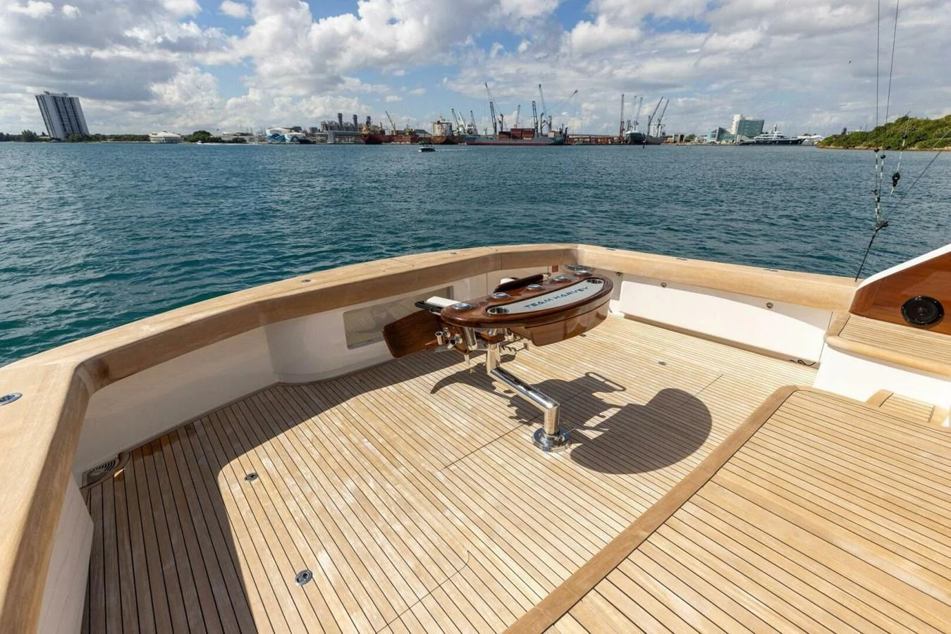 The aft deck features a spacious teak floor with a mounted fighting chair, perfect for fishing enthusiasts. aboard TEAM HARVEY I Yacht for Sale