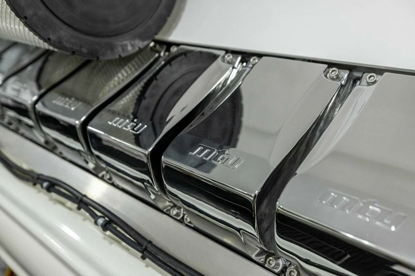 A close-up view of the polished engine components showcases the yacht's powerful and well-maintained machinery. aboard TEAM HARVEY I Yacht for Sale