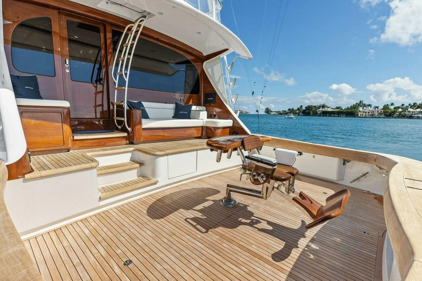 The aft deck features a spacious and inviting area with comfortable seating and a fishing chair, perfect for relaxation and sport. aboard TEAM HARVEY I Yacht for Sale