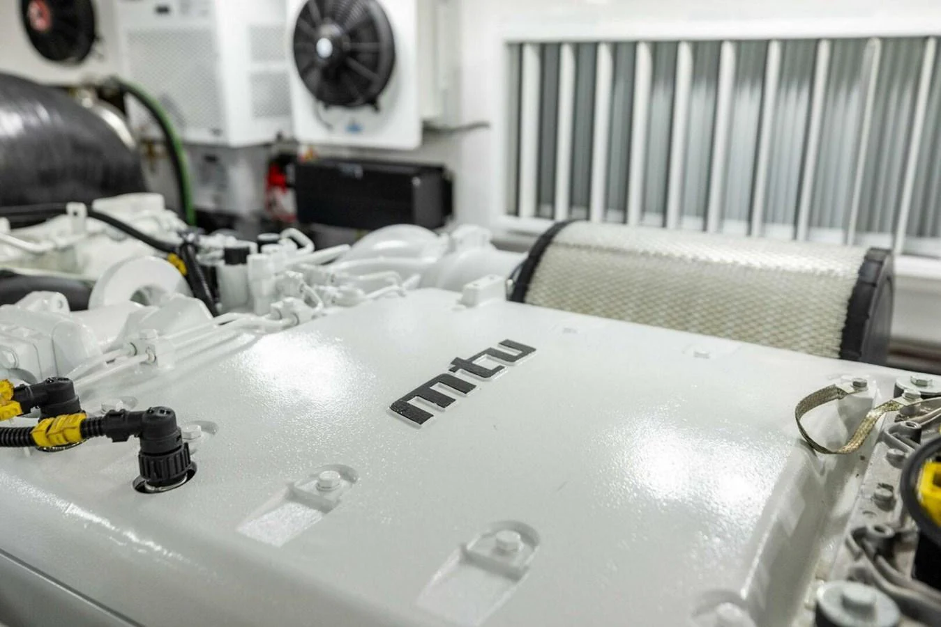 The image showcases the pristine engine room featuring an MTU engine. aboard TEAM HARVEY I Yacht for Sale